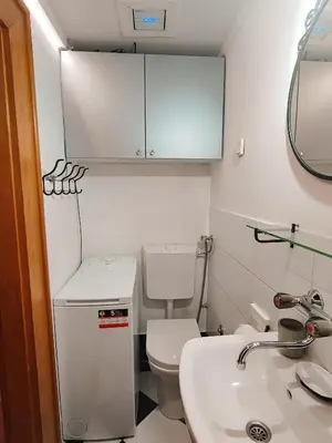 a small bathroom with a toilet and a sink at Republic Square Studio in Belgrade