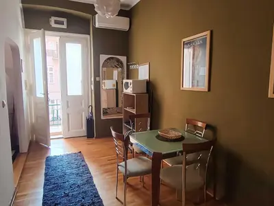 a dining room with a table and chairs in a room at Republic Square Studio in Belgrade