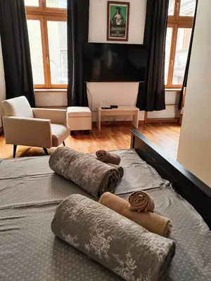 a bedroom with two beds with towels on them at Republic Square Studio in Belgrade