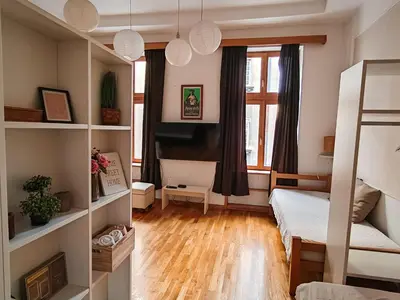 a bedroom with a bunk bed and a window at Republic Square Studio in Belgrade