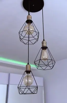 a group of lights hanging from a ceiling at Lux Flat Center in Belgrade