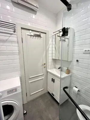 a white bathroom with a toilet and a sink at Artika - Chic & Sunlit Stay in Downtown Belgrade in Belgrade
