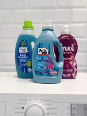 three bottles of cleaner are sitting on a shelf in a refrigerator at Artika - Chic & Sunlit Stay in Downtown Belgrade in Belgrade
