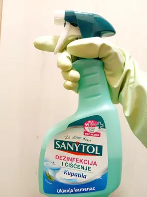 a person holding up a bottle of santol detergent at Bohemian Lux Apartment Skadarlija in Belgrade
