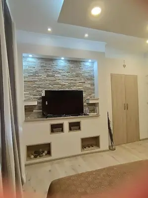 a living room with a flat screen tv on a wall at Bohemian Lux Apartment Skadarlija in Belgrade