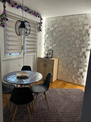 a dining room with a table and chairs at Martina Lux in Belgrade