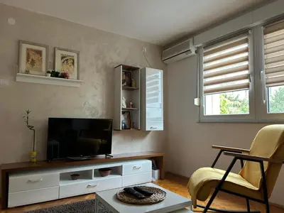 a living room with a flat screen tv sitting on a entertainment center at Martina Lux in Belgrade