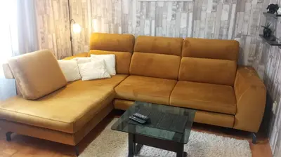 a brown couch in a living room with a table at Apartment MrCvetko FREE PARKING in Bežanija
