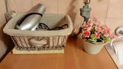 a counter with a basket and flowers on a table at Apartment MrCvetko FREE PARKING in Bežanija