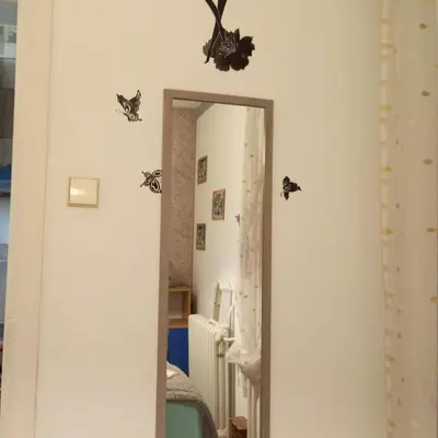 a hallway with bats on the wall and a mirror at Apartment MrCvetko FREE PARKING in Bežanija