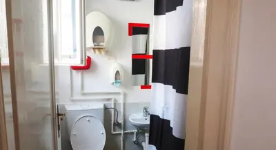 a bathroom with a white toilet and a sink at Hostel El Diablo in Belgrade