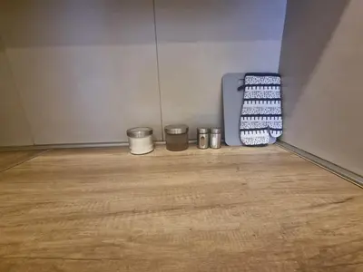 a room with three buckets and a wooden floor at Grand Residence in Bežanija