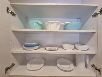 a shelf with bowls and other dishes on it at Grand Residence in Bežanija