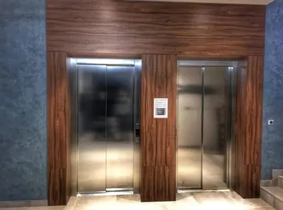 a pair of elevators in a building at Grand Residence in Bežanija