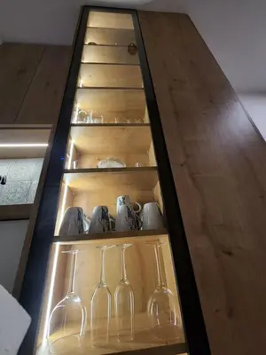 a wooden shelf with glasses and wine glasses at Nancy's Cozy Business Apartment in Bežanija