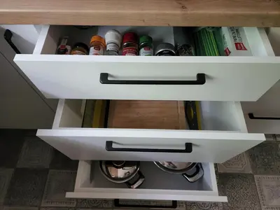 a drawer in a cabinet filled with books at Nancy's Cozy Business Apartment in Bežanija