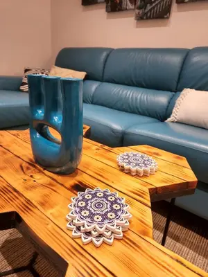 a living room with a blue couch and a table at Nancy's Cozy Business Apartment in Bežanija