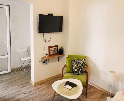 a living room with a green couch and a table at Vukov spomenik in Belgrade