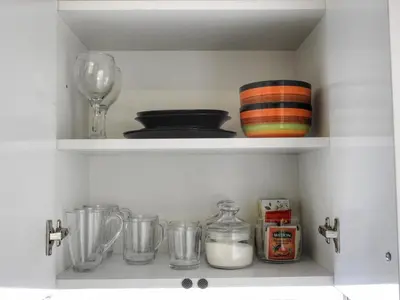 a shelf with bowls and other kitchen items on it at Vukov spomenik in Belgrade
