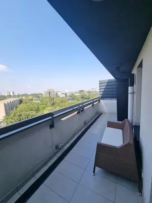 a balcony with a chair sitting on top of a building at Skyline in Belgrade