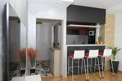a kitchen with white and red stools in a room at Arena Lux in Novi Beograd