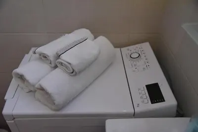 a pile of towels on top of a washing machine at Cloud Downtown apartment in Belgrade