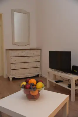 a bowl of fruit sitting on a table in a living room at Cloud Downtown apartment in Belgrade