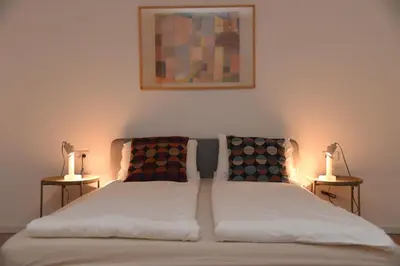 a bedroom with a bed with two lamps on both sides at Cloud Downtown apartment in Belgrade