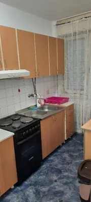 a kitchen with a stove and a sink at Apartman Boba in Ruma