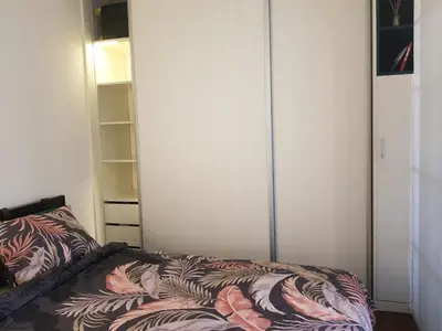 a bedroom with a bed and a closet at Emily apartment in Belgrade