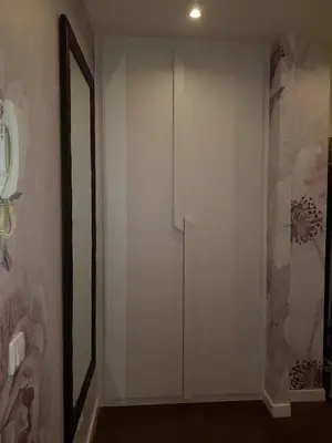 a hallway with a white door and a mirror at Emily apartment in Belgrade