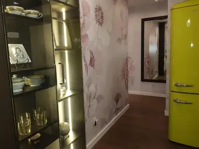 a room with a green refrigerator with flowers on the wall at Emily apartment in Belgrade