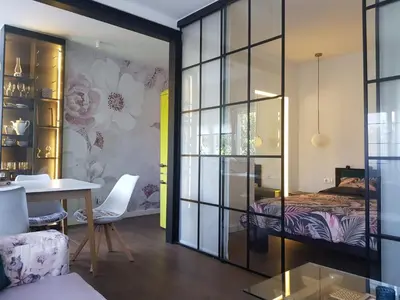 a bedroom with a bed and a table in a room at Emily apartment in Belgrade