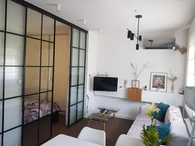 a living room with a couch and a tv at Emily apartment in Belgrade