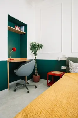a bedroom with a bed and a desk and a chair at DESIGN Apartment 