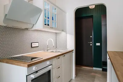 a kitchen with white cabinets and a sink and a door at DESIGN Apartment 