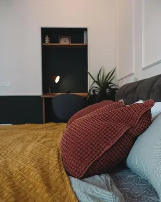 a bed with a pillow sitting on top of it at DESIGN Apartment 