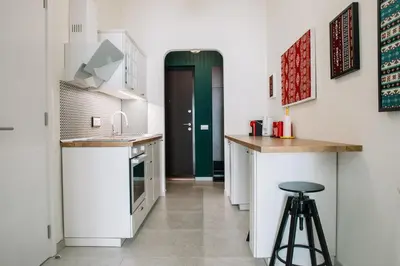 a kitchen with a counter and a stool in it at DESIGN Apartment 
