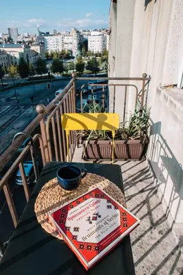 a table with a plate on top of a balcony at DESIGN Apartment 