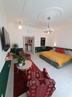 a bedroom with a bed and a couch and a table at DESIGN Apartment 