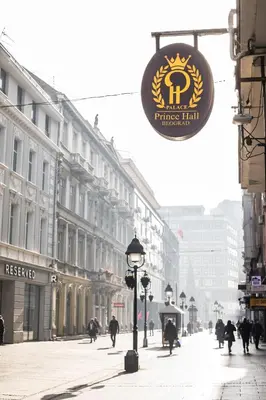 a sign on a street with people walking down a street at Prince Hall in Belgrade