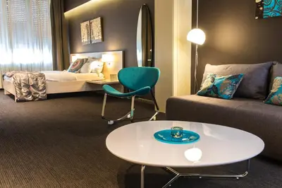 a living room with a couch and a table and a bed at Prince Hall in Belgrade