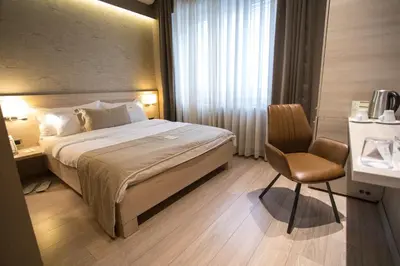 a hotel room with a bed and a chair at Prince Hall in Belgrade