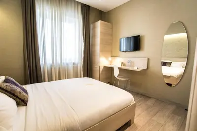 a hotel room with a bed and a mirror at Prince Hall in Belgrade