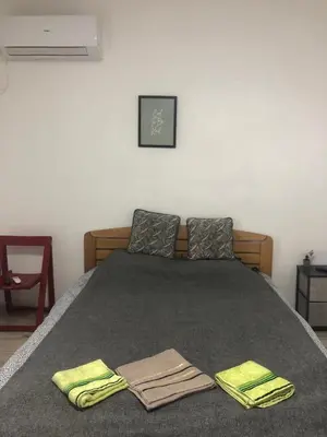 a bedroom with a bed with two towels on it at Central apartment Belgrade in Belgrade