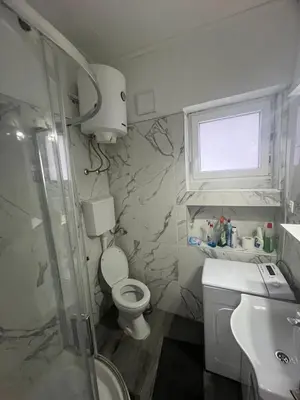 a bathroom with a shower and a toilet and a sink at Central apartment Belgrade in Belgrade