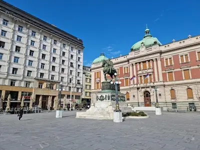 a statue in a plaza in front of a building at Central apartment Belgrade in Belgrade