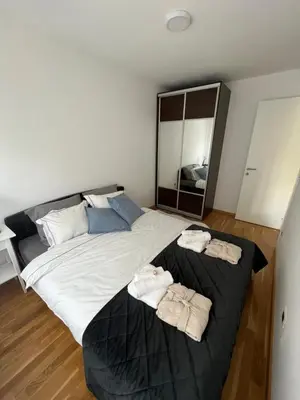 a bedroom with a large bed with two towels on it at Lenka in Dušanovac (historical)