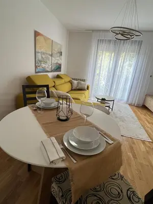 a living room with a table and a couch at Lenka in Dušanovac (historical)