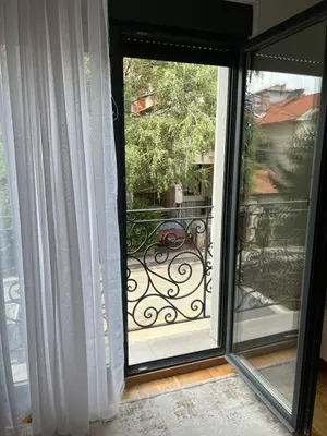 a sliding glass door with a view of a balcony at Lenka in Dušanovac (historical)